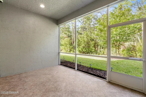 a view of an empty room with glass door
