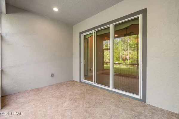 a view of a house with a yard and a large tree