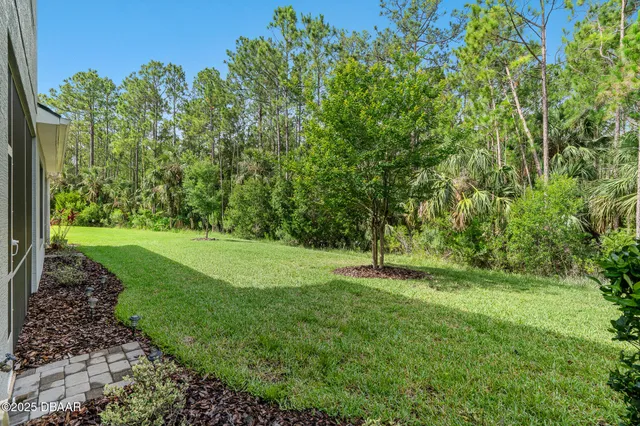 an aerial view of a house with a yard basket ball court and outdoor seating