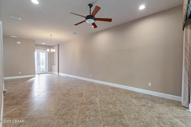 an empty room with a empty space and a ceiling fan