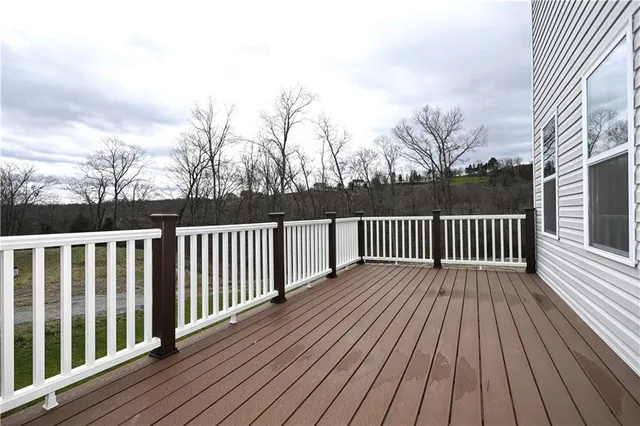 a view of a house with wooden deck