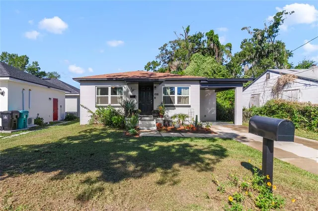 a view of a house with backyard sitting area and garden