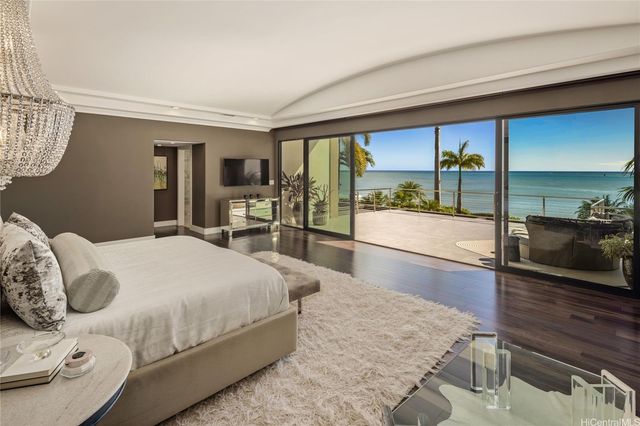 a bedroom with a large bed and a large window