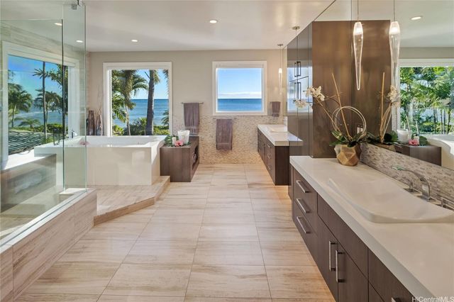 a large bathroom with a large tub and sink