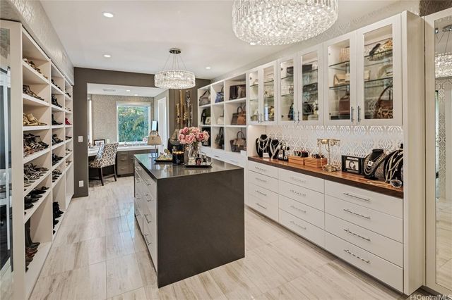 a kitchen with stainless steel appliances kitchen island granite countertop a sink dishwasher stove and wooden cabinets