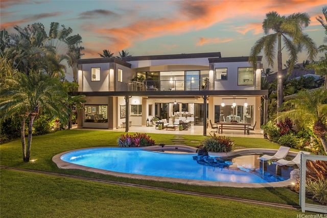 a front view of a house with swimming pool garden and patio