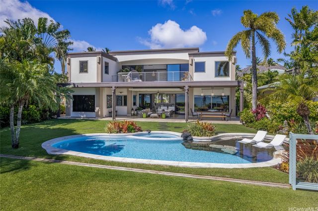 a view of house with swimming pool and yard