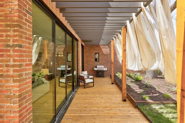 a view of swimming pool with outdoor seating and plants