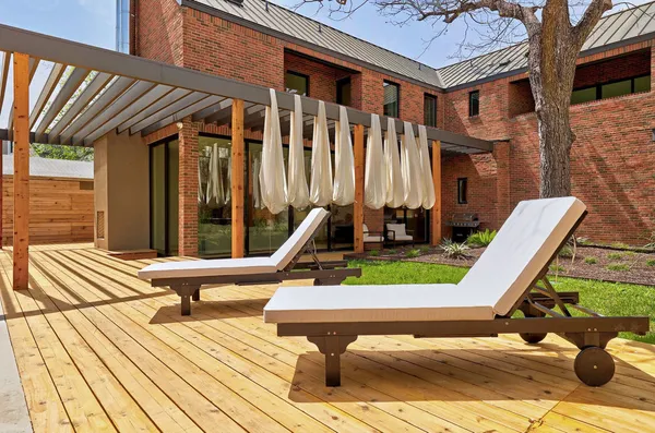 a balcony with chairs and wooden floor