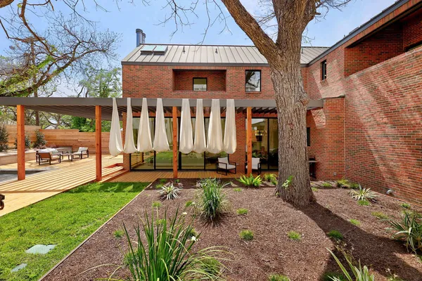 a view of a house with backyard and sitting area