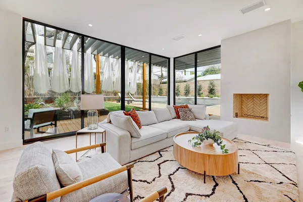 a living room with furniture and a floor to ceiling window