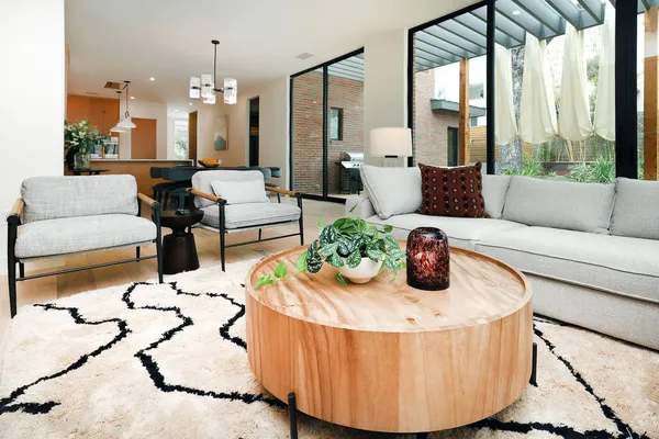 a living room with furniture and a chandelier