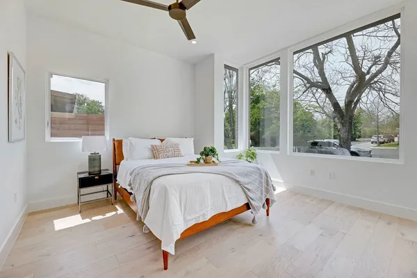 a spacious bedroom with a bed and a large window