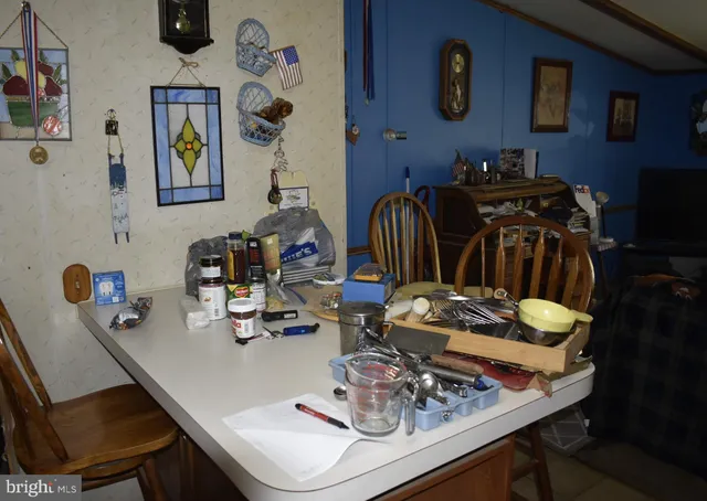 a dining room with furniture a clock and a window