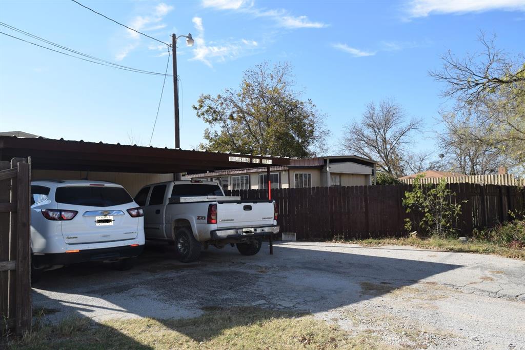 a view of a car park in front of a house
