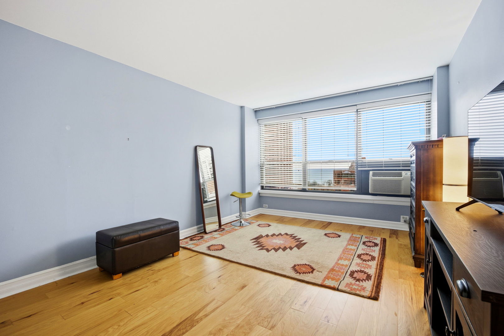 2930 North Sheridan Road, Unit 1912 Chicago, IL 60657 - Photo 12 of 25 a living room with a bed furniture and a window