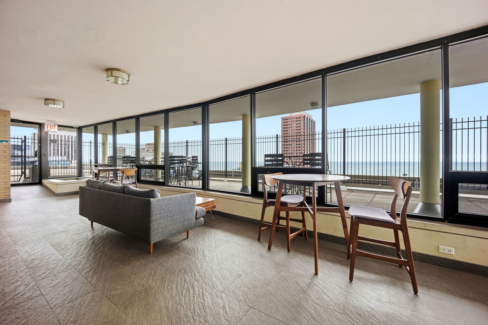 2930 North Sheridan Road, Unit 1912 Chicago, IL 60657 - Photo 18 of 25 a living room with furniture and large windows