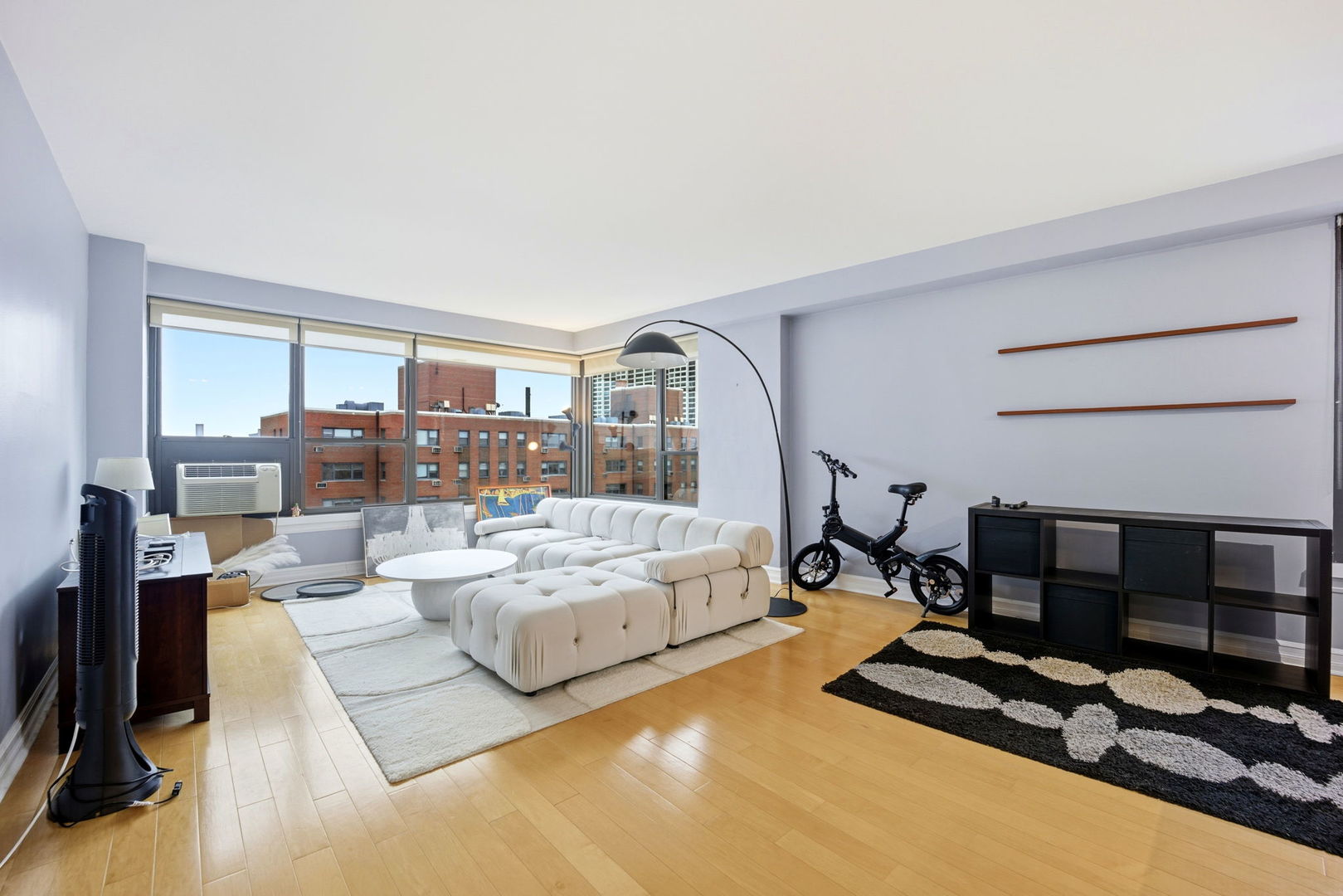 2930 North Sheridan Road, Unit 1912 Chicago, IL 60657 - Photo 2 of 25 a living room with furniture gym equipment and a large window