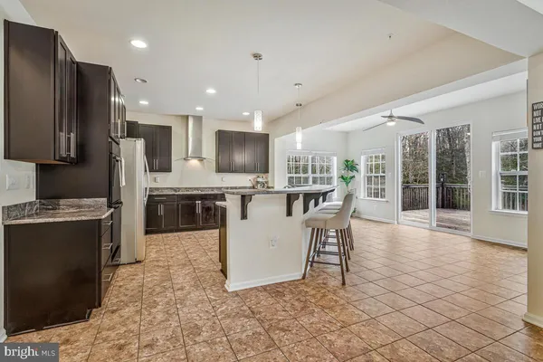 a view of kitchen with granite countertop cabinets table and chairs