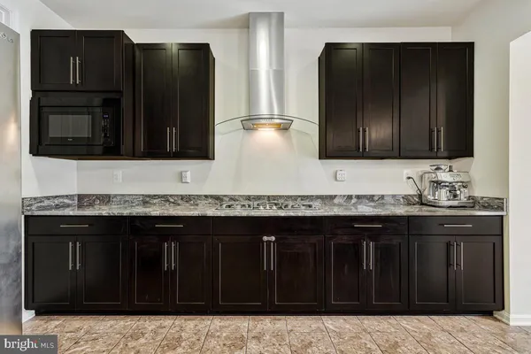 a bathroom with a granite countertop sink a vanity and a large mirror