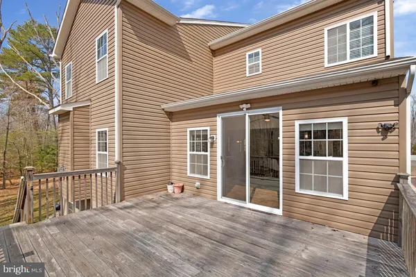 a view of a balcony with wooden floor and fence