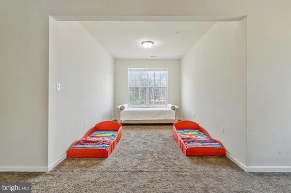 a bedroom with bed and a chandelier