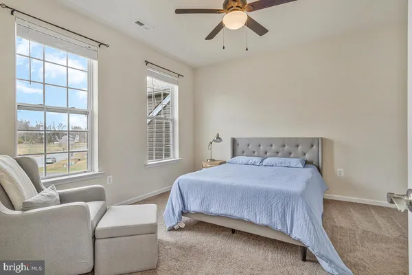 a bathroom with a granite countertop sink and a toilet