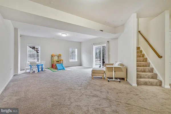 a bathroom with a granite countertop sink a toilet and a large mirror