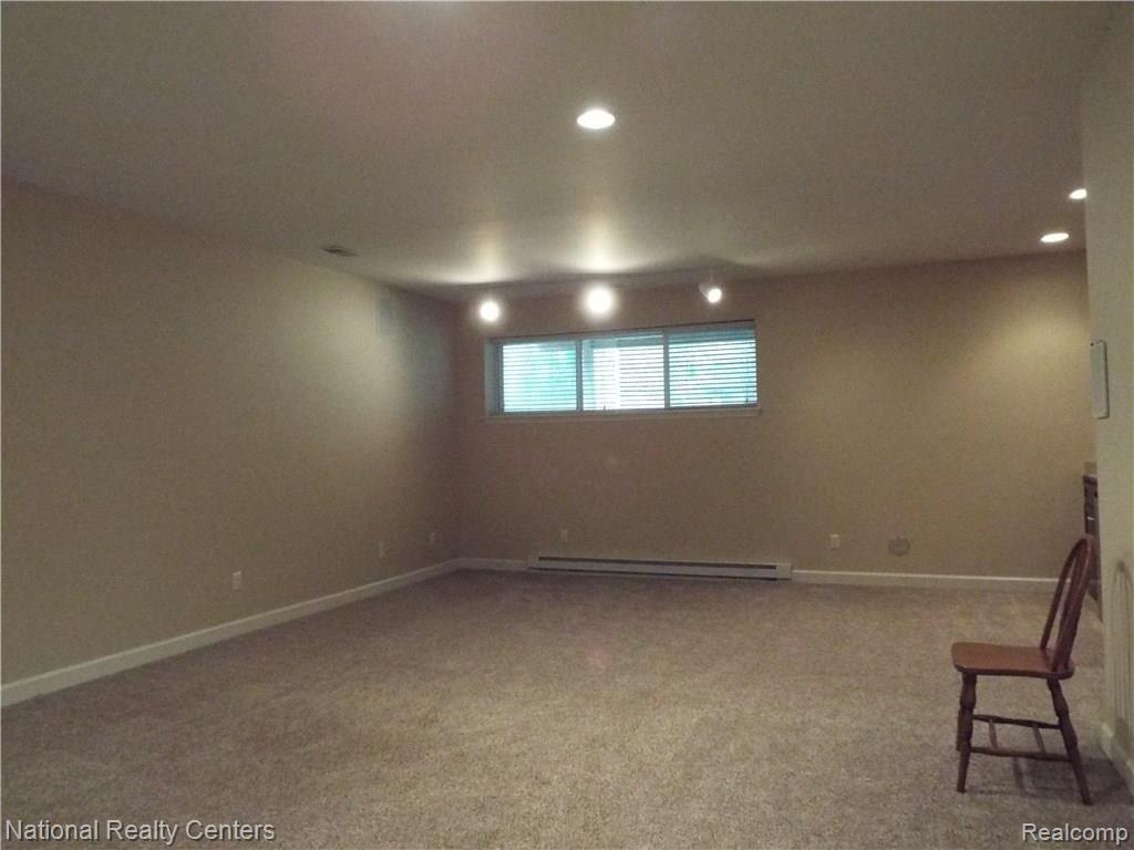 7289 Rabbit Ears Pass, Unit 29 Clarkston, MI 48346 - Photo 29 of 38 Daylight basement FAMILY ROOM with fireplace and wet bar.