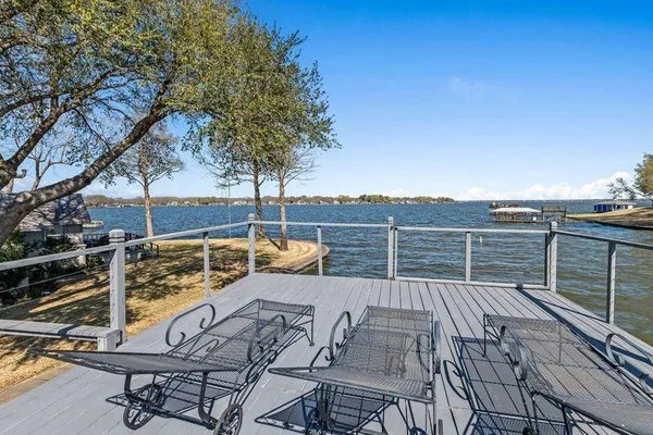 a view of balcony with seating space and wooden fence