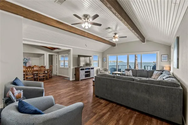 a living room with furniture ceiling fan and a rug