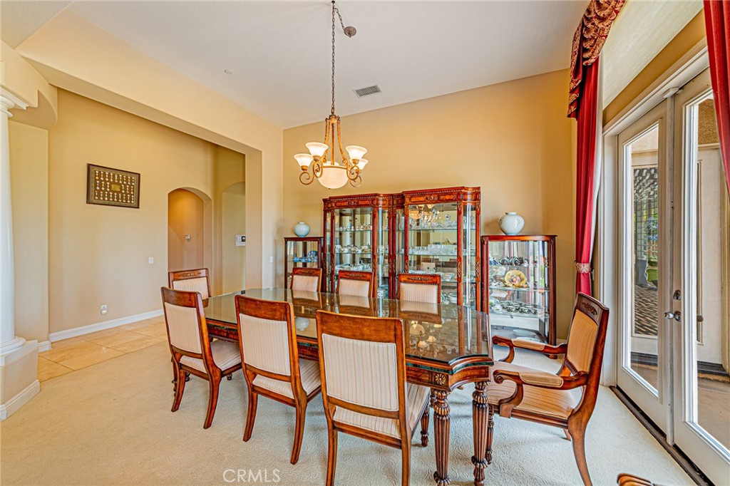 4088 Shady Ridge Circle Corona, CA 92881 - Photo 41 of 47 a dining room with furniture and chandelier kitchen view