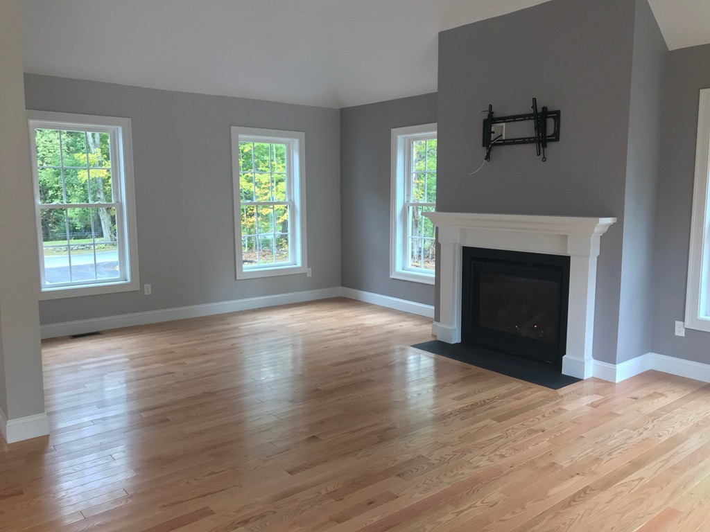 15 Minott Road Westminster, MA 01473 - Photo 6 of 26 an empty room with wooden floor fireplace and windows