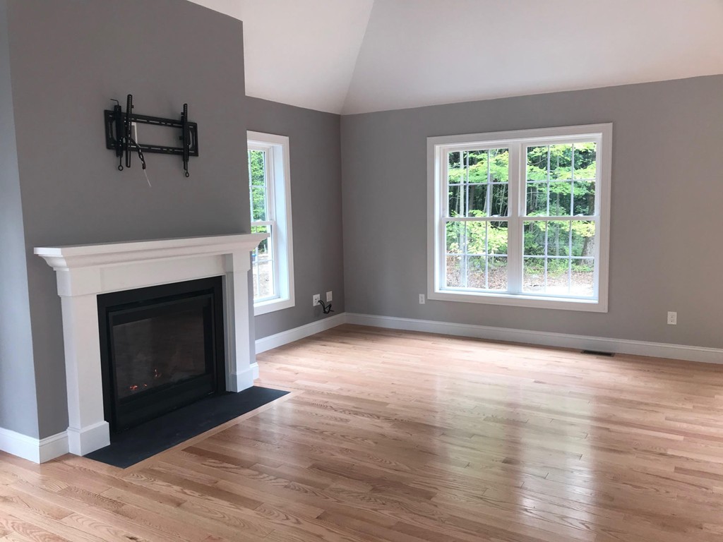 15 Minott Road Westminster, MA 01473 - Photo 7 of 26 a view of empty room with wooden floor and fireplace