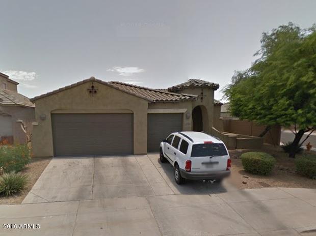 2015 North Rascon Loop Phoenix, AZ 85037 - Photo 1 of 1 a front view of a house with a garden and garage