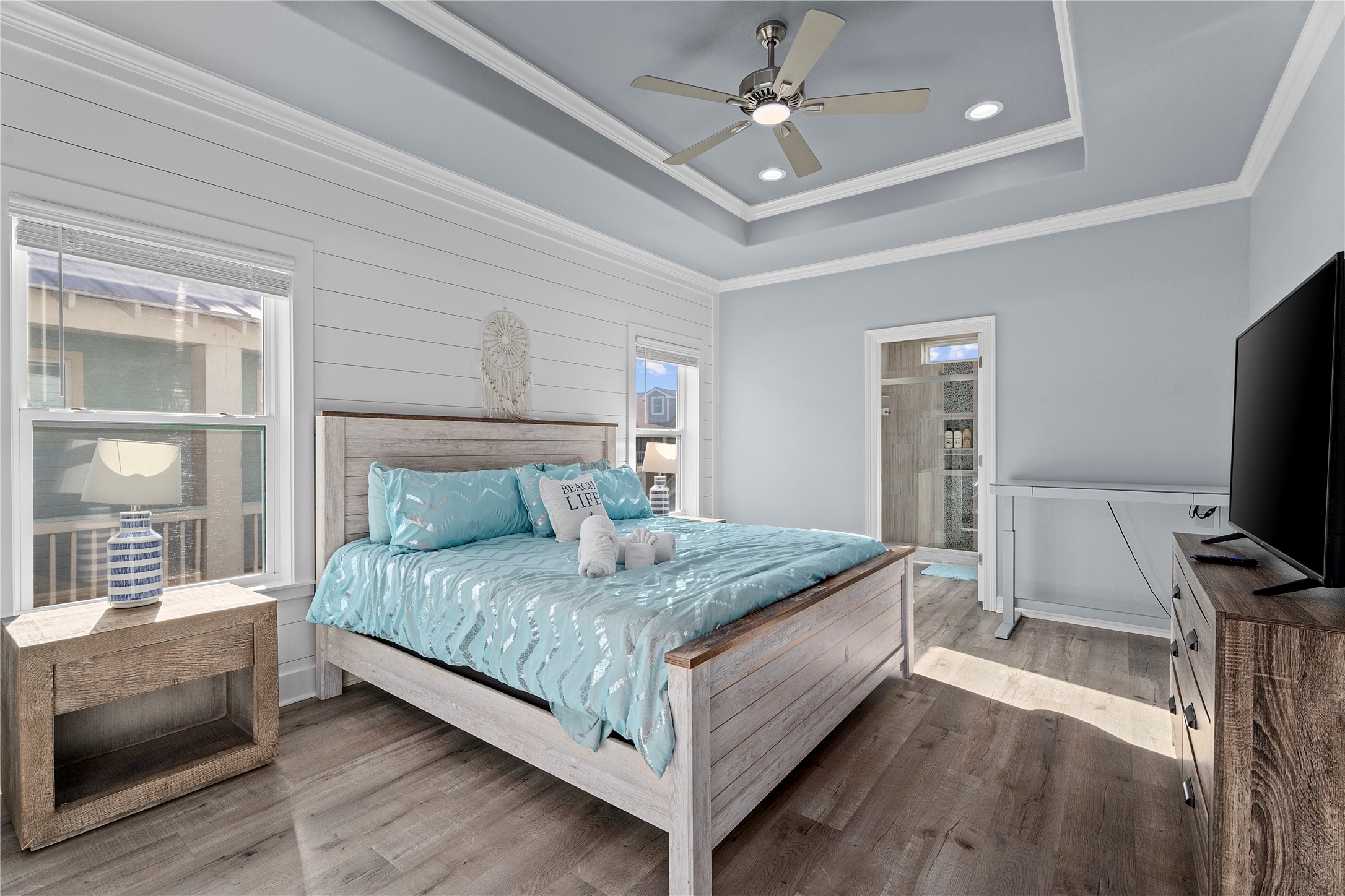 941 South Gateway Road Crystal Beach, TX 77650 - Photo 12 of 43 a bedroom with a bed and a flat screen tv