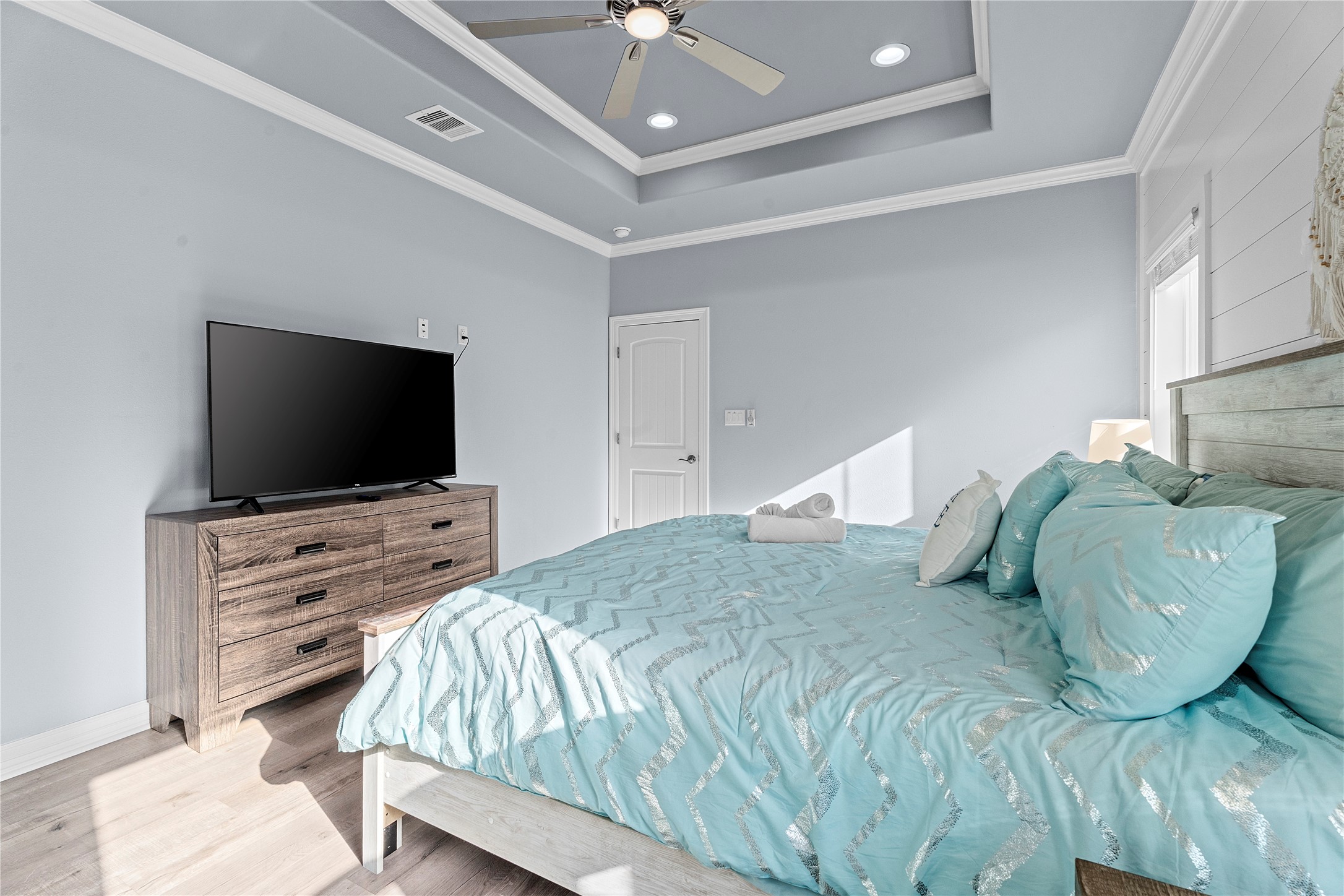 941 South Gateway Road Crystal Beach, TX 77650 - Photo 14 of 43 a bedroom with a bed and a flat screen tv