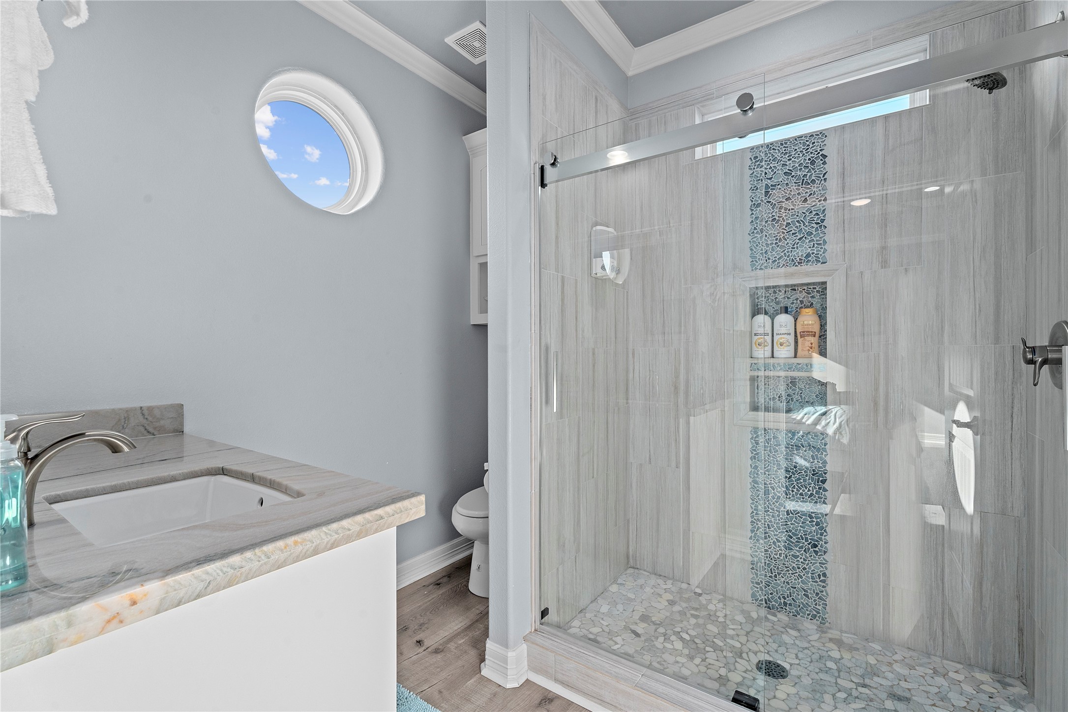 941 South Gateway Road Crystal Beach, TX 77650 - Photo 19 of 43 a bathroom with a granite countertop sink a toilet and shower