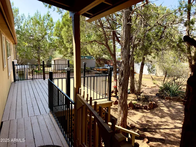 a view of balcony with wooden floor and fence
