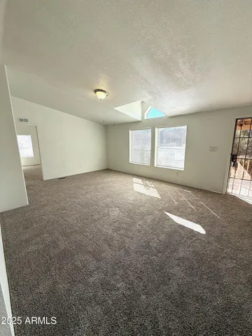 an empty room with windows and closet