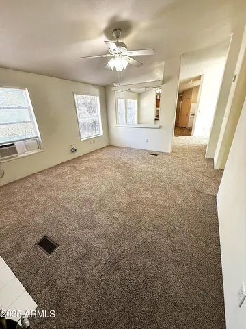 a view of an empty room with windows