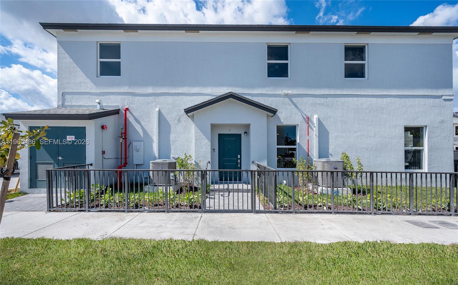 12470 Southwest 248th Street, Unit 1 Homestead, FL 33032 - Photo 2 of 35 a front view of a house with a porch
