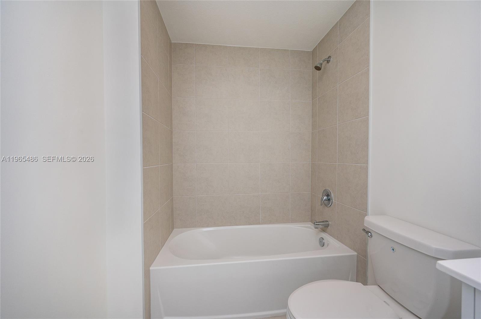 12470 Southwest 248th Street, Unit 1 Homestead, FL 33032 - Photo 22 of 35 a white bath tub sitting next to a white toilet