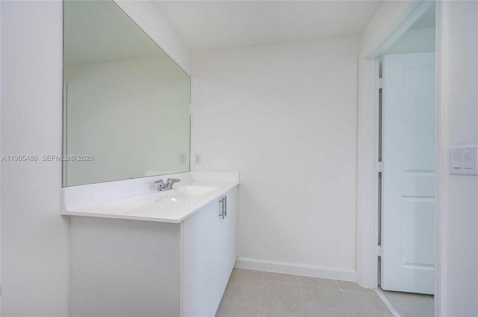 12470 Southwest 248th Street, Unit 1 Homestead, FL 33032 - Photo 23 of 35 a bathroom with a sink and mirror