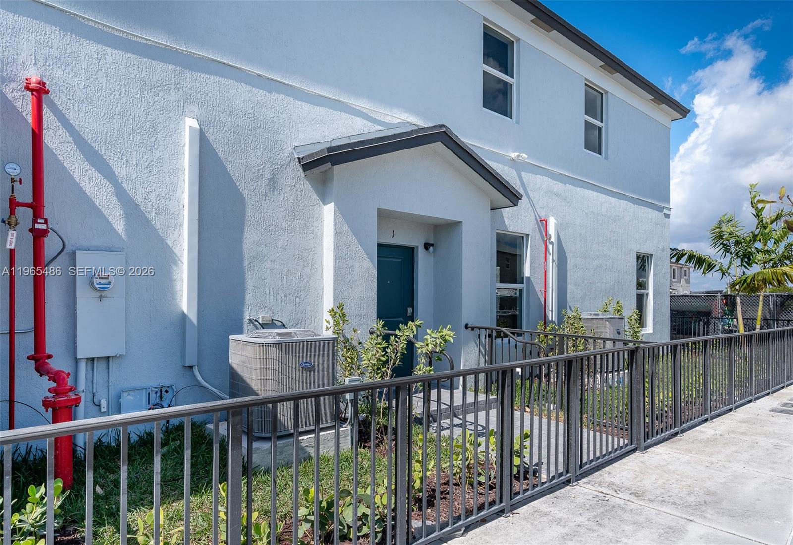 12470 Southwest 248th Street, Unit 1 Homestead, FL 33032 - Photo 3 of 35 a view of a house with wooden fence