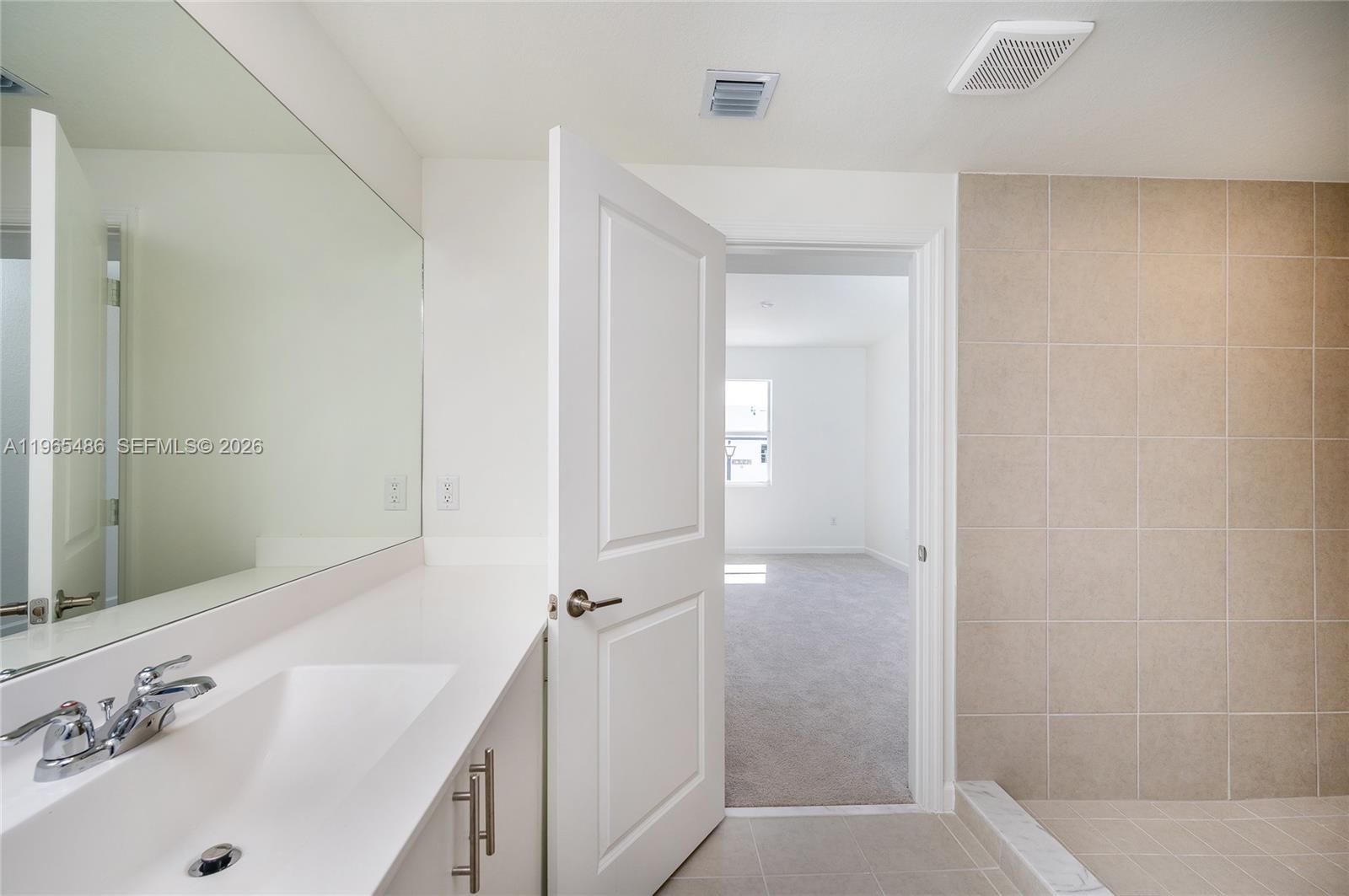 12470 Southwest 248th Street, Unit 1 Homestead, FL 33032 - Photo 34 of 35 a bathroom with a tub sink a mirror and shower