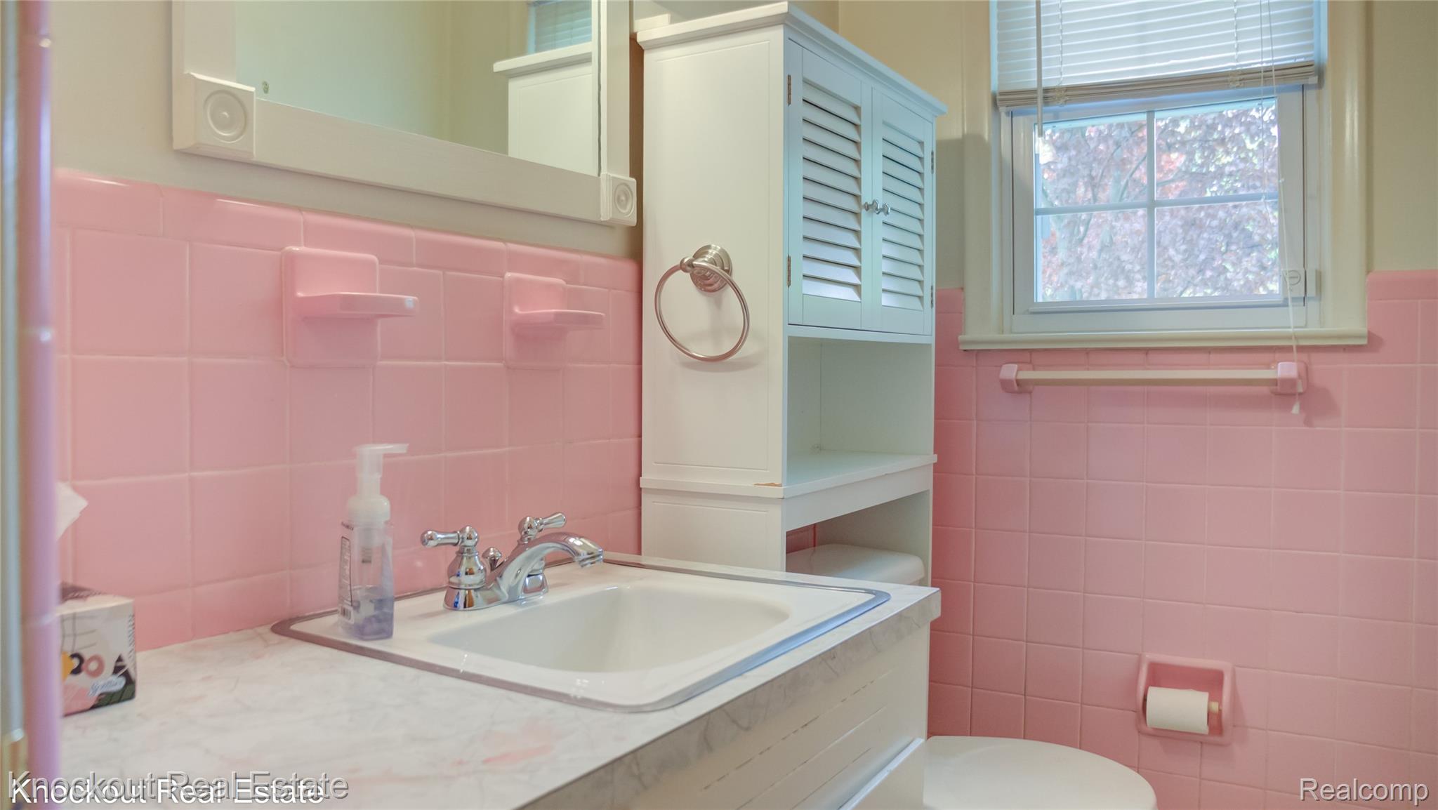 4465 Dirker Road Saginaw, MI 48638 - Photo 23 of 56 Bathroom with tile walls, a wainscoted wall, and vanity