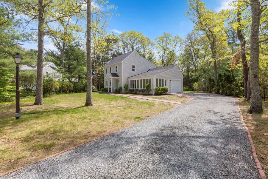 a view of house with yard in front of it