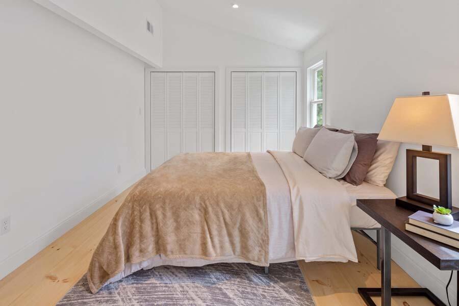 84 Cap'n Lijah's Road Centerville, MA 02632 - Photo 16 of 24 a bedroom with a bed and a lamp