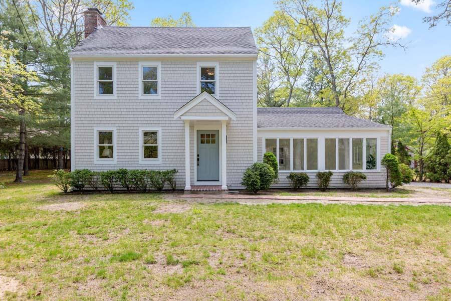 84 Cap'n Lijah's Road Centerville, MA 02632 - Photo 2 of 24 a front view of a house with a yard and garage